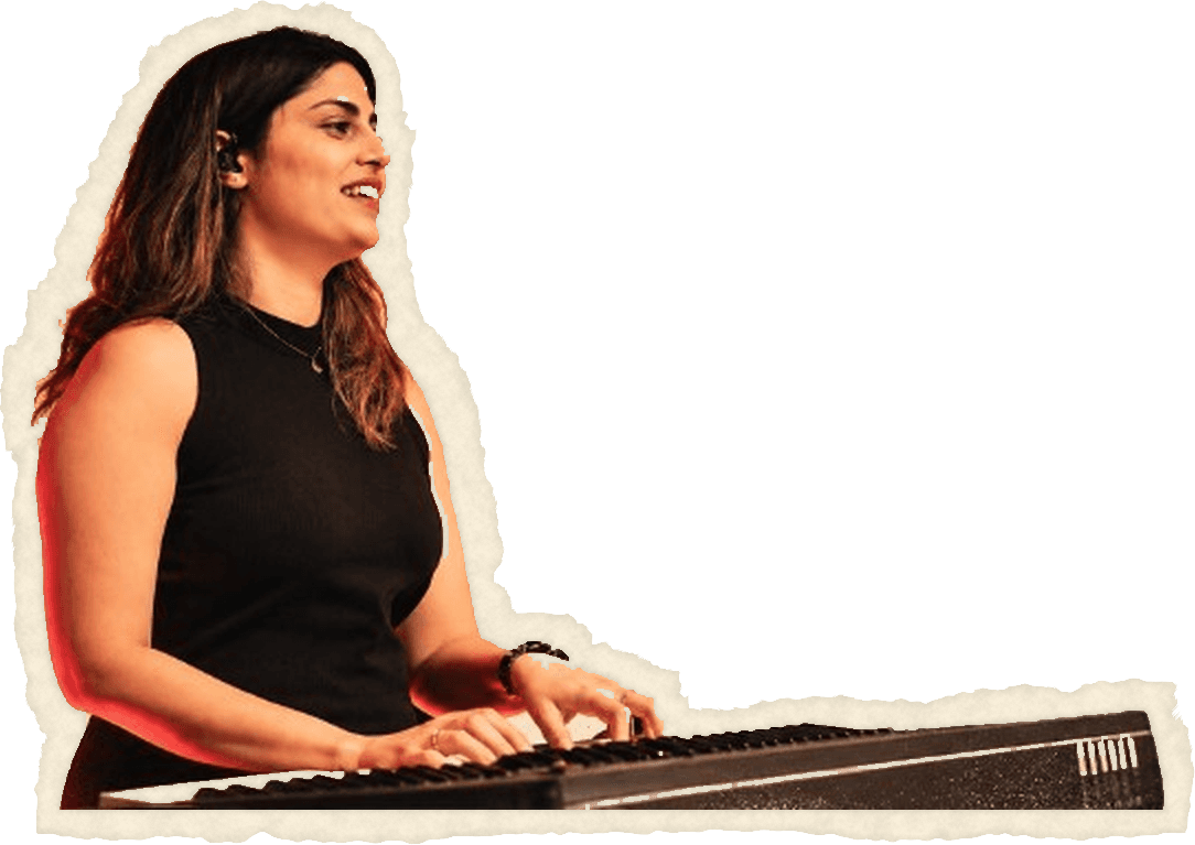 Simran playing a keyboard, smiling